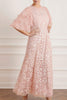 Woman wearing modest Needle & Thread Aurelia Gown in pink strawberry icing color. The gown is adorned in light pink sequin detailing and has three-quarter flare sleeves.