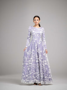  A woman wearing a lilac purple modest gown with a white floral overlay